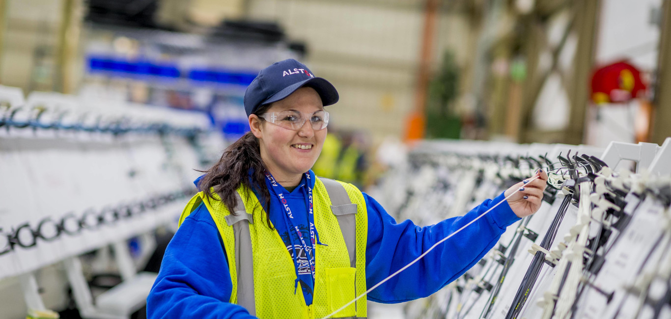 A female worker builds harnesses for the Ottawa Citadis Spirit using a foam board. Hornell, USA, February 2016 Building harnesses for the Ottawa Citadis Spirit