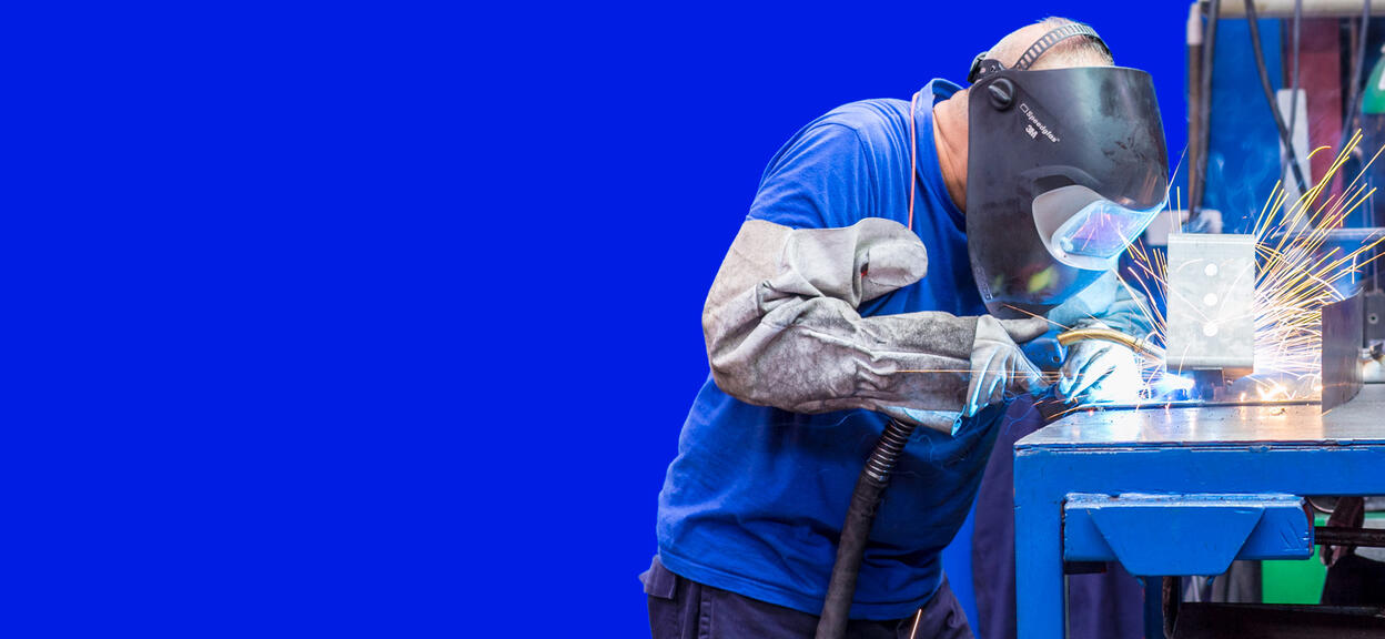 Man making a weld in a factory