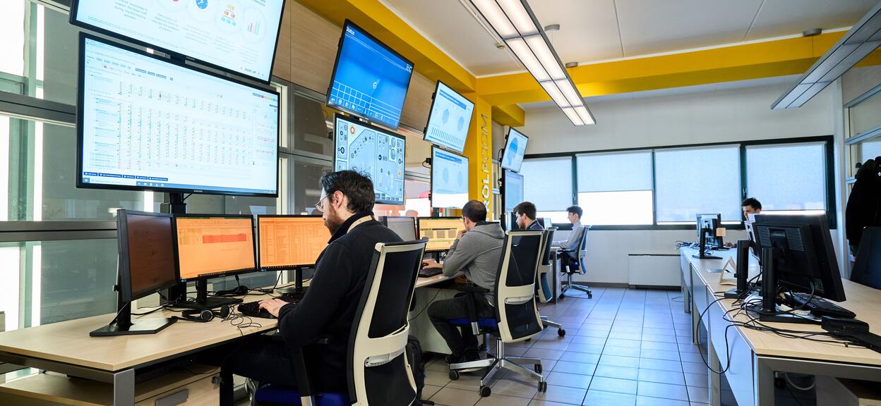 Control room with engineers working at screens