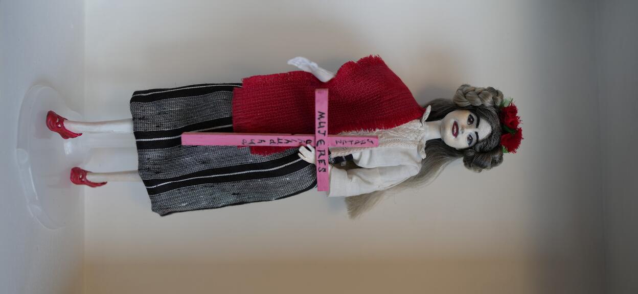 Barbie doll displayed on wall