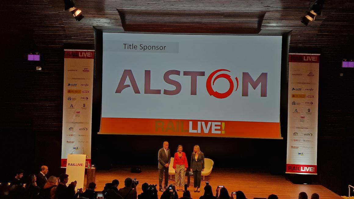 People on stage at Rail Live! 2022 with ALSTOM logo behind