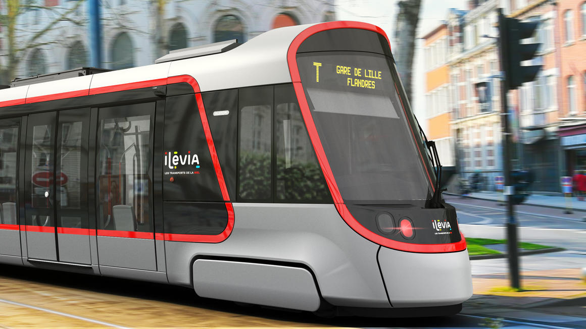 A Citadis tram bearing the logos of Ilevia is shown travelling from left to right along a tree-lined avenue. The train’s display screen shows its destination (Gare de Lille Flandres)