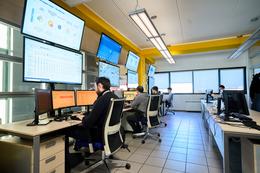 Control room with engineers working at screens