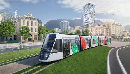 This artist's drawing shows a tram moving from right to left in an urban environment. The tram has a white livery with green, blue and red spots. It bears the Citadis name on its side and on the display above the windscreen. A second tram can be seen in the distance, on the right-hand side. The trams are travelling along a grassy avenue. Buildings can be seen in the background and mountains in the distance.