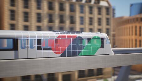 Une image de synthèse présente une rame de train circulant sur un viaduc (de la gauche vers la droite). La rame porte une livrée avec des taches de couleur rouge, verte et bleue, ainsi qu’un quadrillage blanc. L’arrière-plan est flouté. On devine des immeubles de plusieurs étages de couleur ocre.