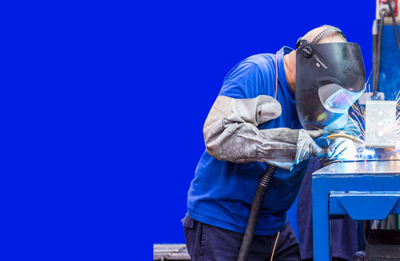 Man making a weld in a factory