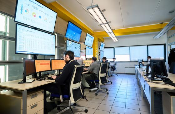 Control room with engineers working at screens