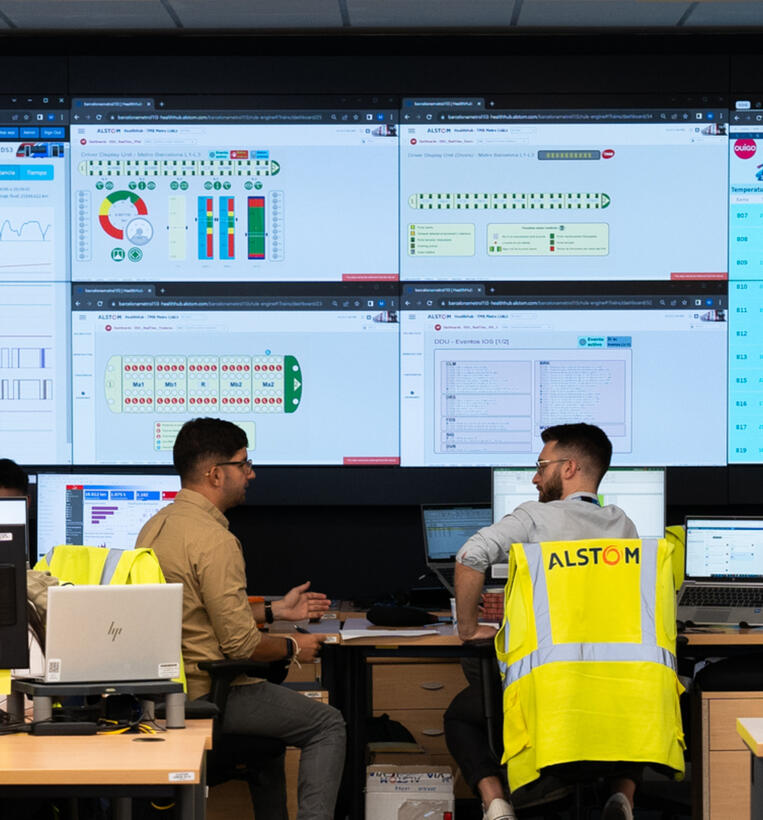 Employees working at video wall for digital services in Madrid