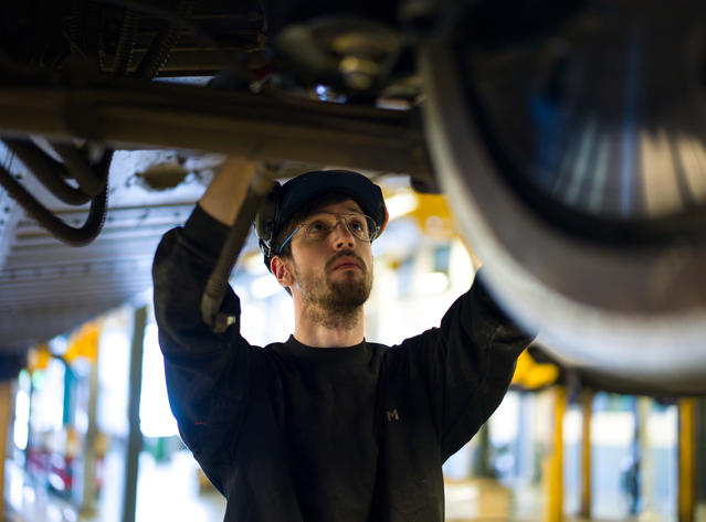 Alstom employee works on a train in maintenance depot